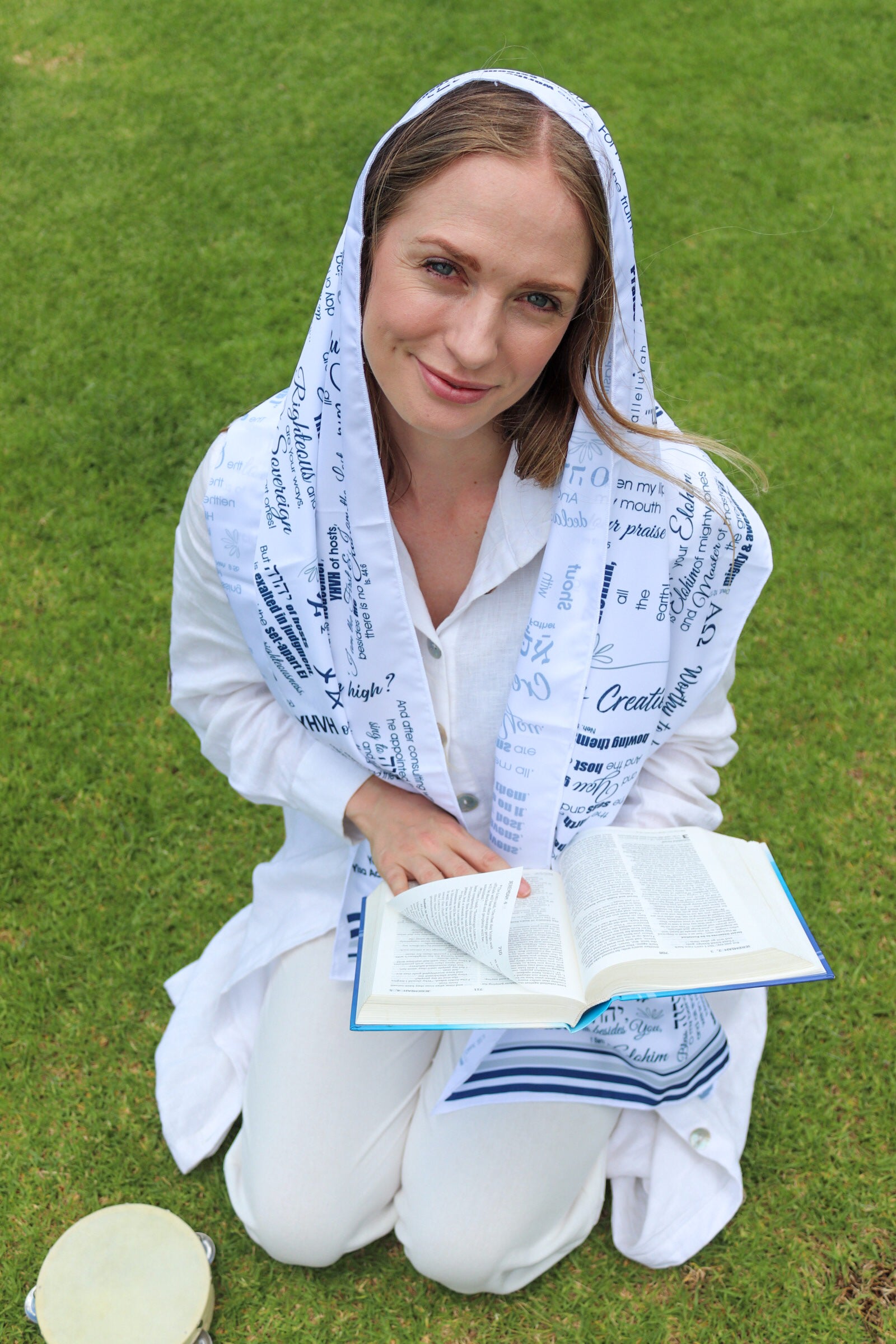 woman wearing praise scripture faith wrap while reading bible outdoors