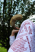person wearing red protection faith wrap with scripture during prayer outdoors
